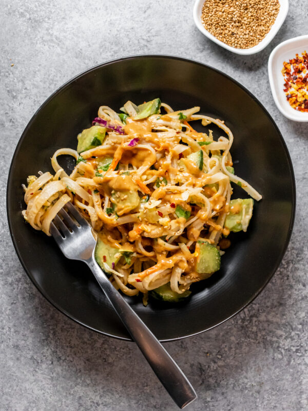 Close up of nutty peanut noodles in a bowl