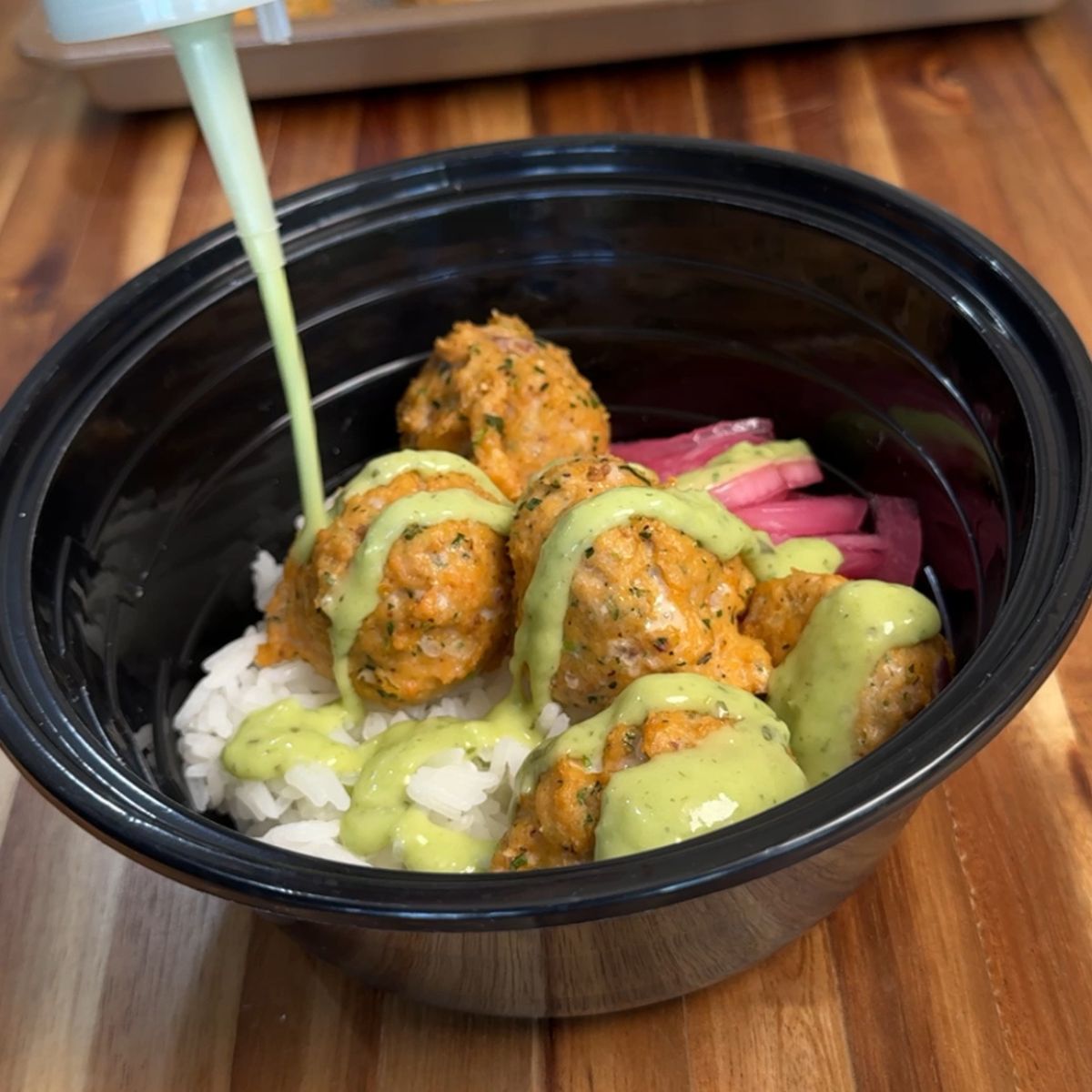 Baked salmon meatballs with avocado crema